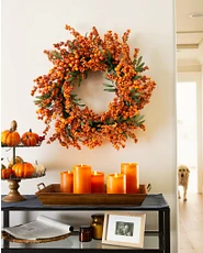 Fall fireplace mantel décor with fall wreath, pumpkins, and LED candles on sidetable